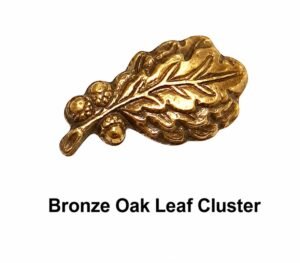 Close-up of a Bronze Oak Leaf Cluster military award device on a white background, used to denote additional awards of the same U.S. military decoration.