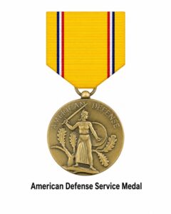 American Defense Service Medal displayed on a white background with its gold, blue, white, and red ribbon and bronze medal, awarded for U.S. military service during the national defense period before World War II (1939–1941).